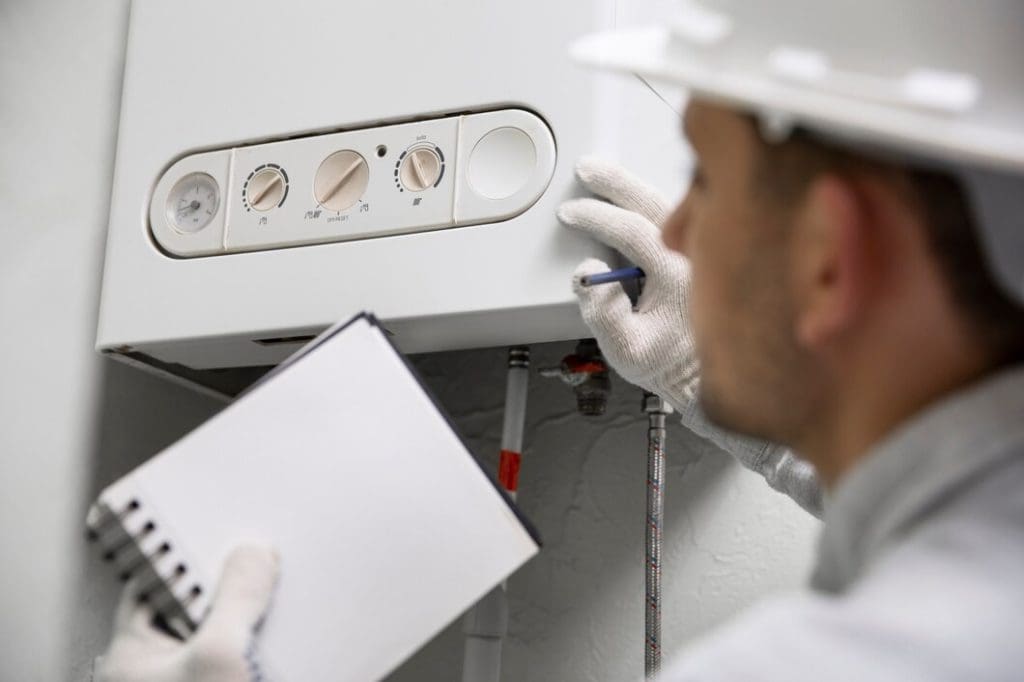 Plumber Inspecting the water heater machine | RossCo Service Plumbers in Tacoma