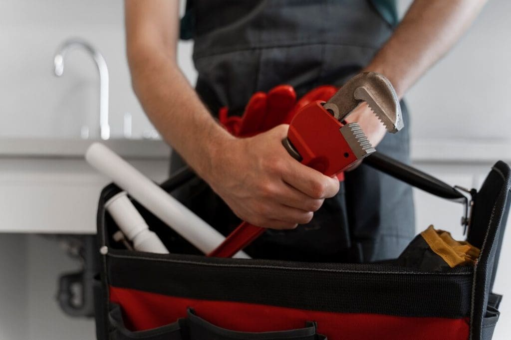 Plumber Holding a wrench | RossCo Service Plumbers in Tacoma