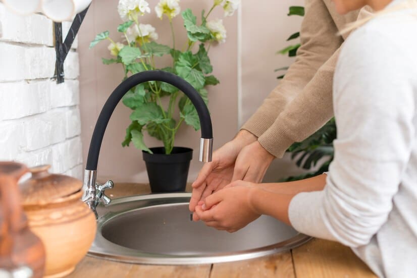 Two Individuals Washing Their Hands in the Sink | RossCo Service Plumbers in Tacoma